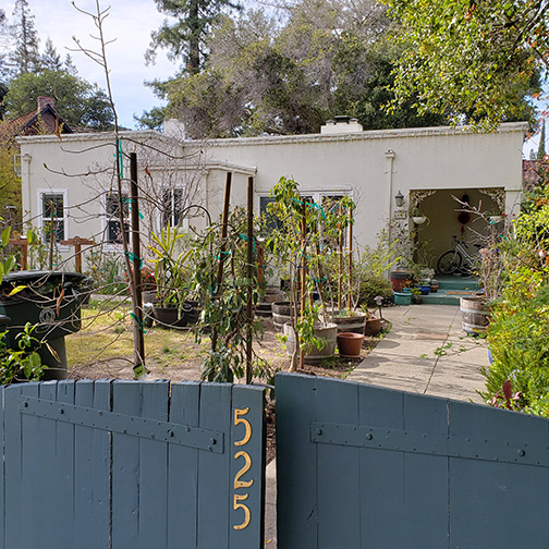 front of house behind gate with address