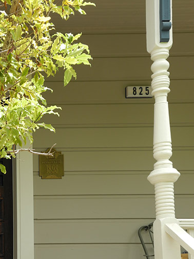 porch with date plaque and address