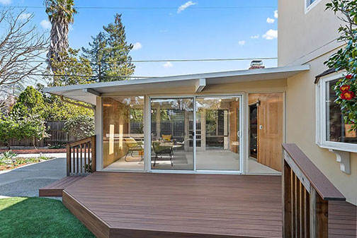 deck and glass walled room at rear