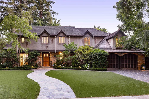 eevening view of front with driveway