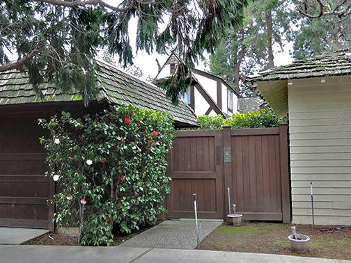 cottage behind fence