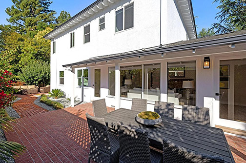 back of house with addition n the left and original ranch-style on the right
