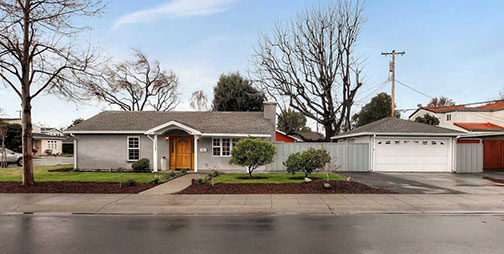 Original home and garage on rainy day