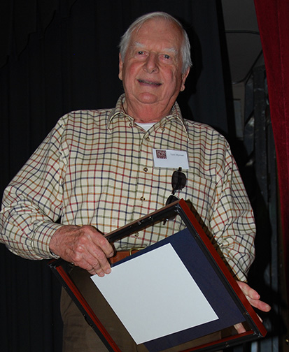 Tom Wyman receiving plaque